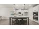 Open kitchen layout with an island with bar stools, modern appliances, and seamless integration with the dining area at 64 Lakeview Pt, Dallas, GA 30157