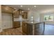 Modern kitchen with wood cabinets, granite countertops, and large center island, perfect for cooking at 64 Lakeview Pt, Dallas, GA 30157