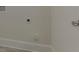 Utility room is unfinished, showing the washer and dryer hookups, with a simple concrete floor at 64 Lakeview Pt, Dallas, GA 30157