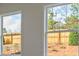 Home interior with double windows overlooking a wooded backyard with a privacy fence at 64 Lakeview Pt, Dallas, GA 30157