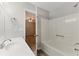 Bright bathroom featuring a sleek white sink and a tub with a showerhead, complemented by modern fixtures at 708 Wind Song Trce, Woodstock, GA 30189