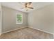 Bedroom with plush carpet, a ceiling fan, and a window providing natural light at 708 Wind Song Trce, Woodstock, GA 30189
