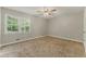 Spacious carpeted bedroom with ample natural light and a ceiling fan at 708 Wind Song Trce, Woodstock, GA 30189