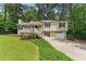 Charming split-level home with a well-maintained lawn and inviting front porch at 708 Wind Song Trce, Woodstock, GA 30189