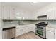 Kitchen featuring stainless steel appliances, ample cabinet space, and new countertops at 708 Wind Song Trce, Woodstock, GA 30189