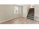 Room with hardwood floors, stairs, neutral colors, and bright light at 708 Wind Song Trce, Woodstock, GA 30189