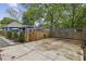 Spacious backyard features a large parking pad, full fence, and nice landscaping near the house at 1211 Mortimer Se Pl, Atlanta, GA 30317