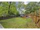Large, well-maintained backyard with a shed, garden beds, and a cozy seating area at 1211 Mortimer Se Pl, Atlanta, GA 30317