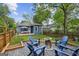Spacious backyard with a fire pit area surrounded by blue Adirondack chairs at 1211 Mortimer Se Pl, Atlanta, GA 30317