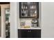 Chic bar area with glass-front cabinets, marble countertop, and a modern espresso machine at 1211 Mortimer Se Pl, Atlanta, GA 30317