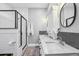 Bright bathroom with a double sink vanity, marble countertops and modern fixtures at 1211 Mortimer Se Pl, Atlanta, GA 30317