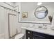 Bright bathroom with a marble vanity and shower with patterned curtain at 1211 Mortimer Se Pl, Atlanta, GA 30317