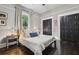 Bedroom featuring large closets, neutral colors, hardwood floors and natural light from the window at 1211 Mortimer Se Pl, Atlanta, GA 30317