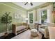 Cozy bedroom featuring a modern crib, soft natural lighting, and neutral decor at 1211 Mortimer Se Pl, Atlanta, GA 30317