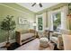Cozy Bedroom featuring a crib, comfortable armchair, and bright natural light at 1211 Mortimer Se Pl, Atlanta, GA 30317