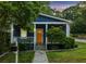Charming blue bungalow with a welcoming yellow front door and well-manicured landscaping at 1211 Mortimer Se Pl, Atlanta, GA 30317