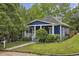 Charming blue bungalow with a manicured front yard and lush landscaping at 1211 Mortimer Se Pl, Atlanta, GA 30317