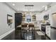 Eat-in kitchen with white cabinetry, stainless steel appliances, and a central wooden table at 1211 Mortimer Se Pl, Atlanta, GA 30317
