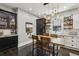 Bright kitchen with white and black cabinets, stainless appliances, and a wooden table at 1211 Mortimer Se Pl, Atlanta, GA 30317