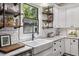 Well-lit kitchen featuring subway tile backsplash, open shelves, and stainless appliances at 1211 Mortimer Se Pl, Atlanta, GA 30317