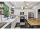 Modern kitchen with stainless steel appliances, stylish lighting, and an island dining area at 1211 Mortimer Se Pl, Atlanta, GA 30317