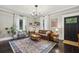 Inviting living room featuring a leather sofa, vintage rug, and natural light at 1211 Mortimer Se Pl, Atlanta, GA 30317
