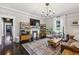 Comfortable living room featuring modern fixtures, hardwood floors, and stylish shelving at 1211 Mortimer Se Pl, Atlanta, GA 30317