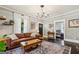 Bright living room featuring a leather sofa, decorative rug, and elegant chandelier at 1211 Mortimer Se Pl, Atlanta, GA 30317