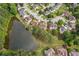 Aerial view of the house near a lake and beautiful landscaping at 1316 Wind Chime Ct, Lawrenceville, GA 30045