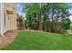 Well-maintained backyard features lush lawn and mature trees at 1316 Wind Chime Ct, Lawrenceville, GA 30045