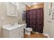 Bathroom featuring a vanity with framed mirror, toilet, and shower with curtain at 1316 Wind Chime Ct, Lawrenceville, GA 30045
