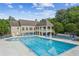 A picturesque community pool surrounded by lounge chairs and landscaping at 1316 Wind Chime Ct, Lawrenceville, GA 30045