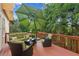Relaxing deck featuring comfortable outdoor seating and a serene view of the surrounding trees at 1316 Wind Chime Ct, Lawrenceville, GA 30045