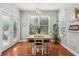 Charming dining area with natural light, hardwood floors, and access to the outdoor deck at 1316 Wind Chime Ct, Lawrenceville, GA 30045