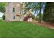 Exterior of the house showcases backyard and deck with stairs at 1316 Wind Chime Ct, Lawrenceville, GA 30045