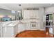 Well-lit kitchen with stainless appliances, white cabinetry, and an open layout into the dining area at 1316 Wind Chime Ct, Lawrenceville, GA 30045