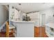 Bright kitchen featuring white cabinets, stainless steel appliances, and a convenient breakfast bar at 1316 Wind Chime Ct, Lawrenceville, GA 30045
