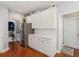 Functional kitchen features stainless steel refrigerator, white cabinets, and easy access to the hallway at 1316 Wind Chime Ct, Lawrenceville, GA 30045