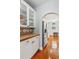 Kitchen featuring white cabinetry, a stainless steel refrigerator, and an arched entryway at 1316 Wind Chime Ct, Lawrenceville, GA 30045