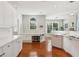 Well-appointed kitchen with white cabinetry, stainless steel appliances, and a built-in desk area at 1316 Wind Chime Ct, Lawrenceville, GA 30045