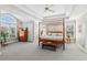 Bright main bedroom with trey ceilings, a four poster bed, and large windows at 1316 Wind Chime Ct, Lawrenceville, GA 30045