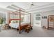 Bright main bedroom with trey ceilings, a four poster bed, and access to the bath at 1316 Wind Chime Ct, Lawrenceville, GA 30045