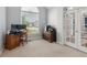 Home office features a large window, wood desk and cabinets, and a chair at 1316 Wind Chime Ct, Lawrenceville, GA 30045