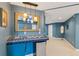 Modern basement bar area featuring blue tile, a mini-fridge, and decorative lighting for an inviting social space at 1316 Wind Chime Ct, Lawrenceville, GA 30045
