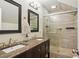 Modern bathroom features double sinks, a marble countertop, and tiled shower at 2610 Cheney St, Atlanta, GA 30344