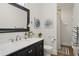 Elegant bathroom with a dark vanity, marble countertop, and a shower with neutral tiling and a glass door at 2610 Cheney St, Atlanta, GA 30344