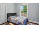 Bright bedroom with a truck-themed comforter, hardwood floors, and a large window providing ample light at 2610 Cheney St, Atlanta, GA 30344