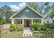 Charming home featuring a cozy front porch, a well-manicured lawn, and lovely landscaping at 2610 Cheney St, Atlanta, GA 30344
