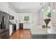 Modern kitchen with white cabinets, stainless steel appliances, and a marble countertop island at 2610 Cheney St, Atlanta, GA 30344