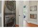 Convenient laundry area with a stacked washer and dryer and doorway access to another room at 2610 Cheney St, Atlanta, GA 30344